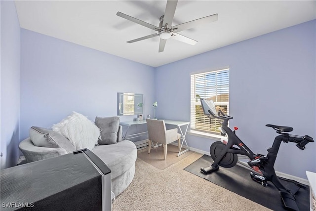 exercise room featuring a ceiling fan, baseboards, and carpet floors