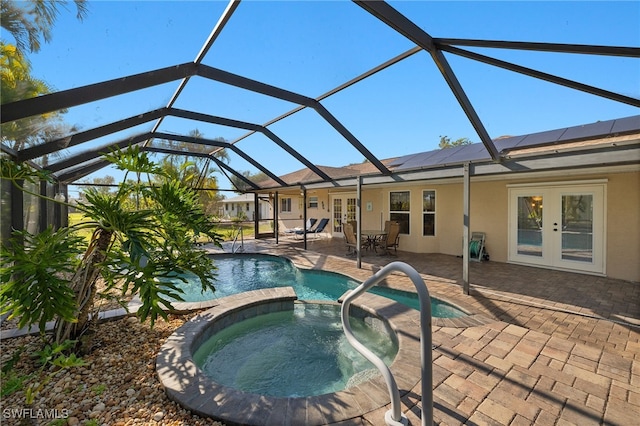 view of swimming pool with a patio, french doors, glass enclosure, and a pool with connected hot tub