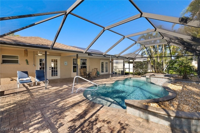 view of swimming pool featuring a patio, french doors, and glass enclosure