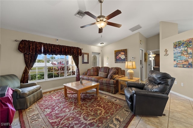 living area featuring lofted ceiling, light tile patterned flooring, visible vents, and a ceiling fan