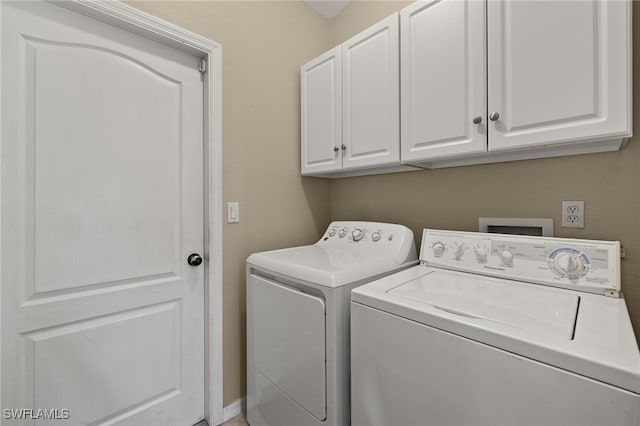 washroom featuring cabinet space and washing machine and dryer