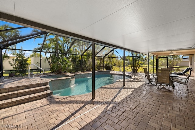 view of swimming pool with glass enclosure, a patio area, and a pool with connected hot tub