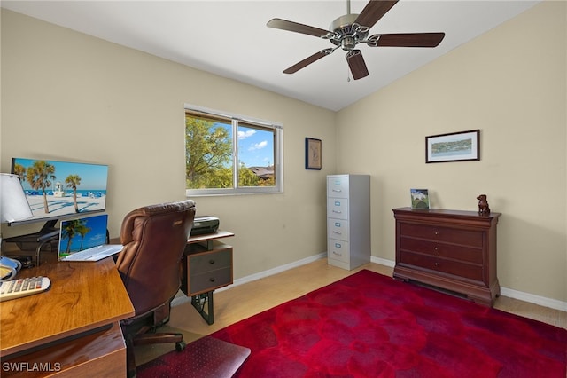 office space with a ceiling fan, lofted ceiling, and baseboards