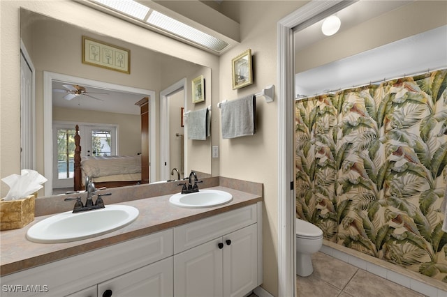 ensuite bathroom featuring toilet, tile patterned flooring, ensuite bath, and a sink