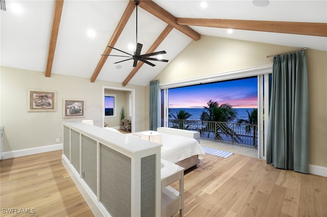 bedroom with beamed ceiling, light wood-style floors, and baseboards