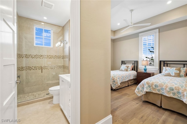 bedroom featuring light wood finished floors, visible vents, recessed lighting, and ensuite bathroom