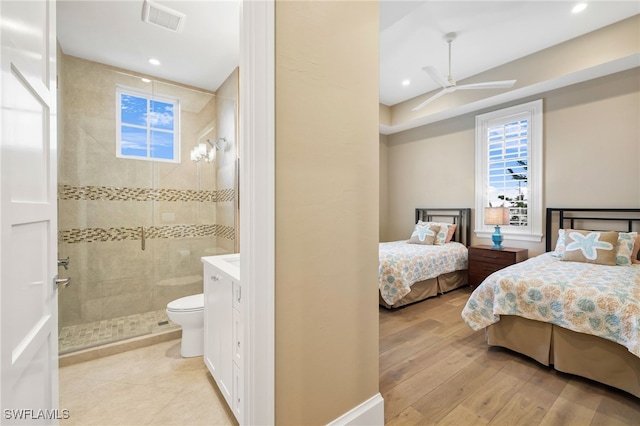 bedroom featuring light wood-type flooring, ensuite bath, visible vents, and recessed lighting