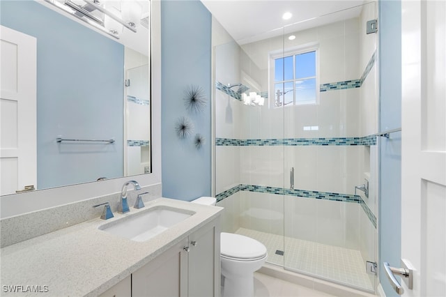 bathroom with vanity, a shower stall, toilet, and recessed lighting