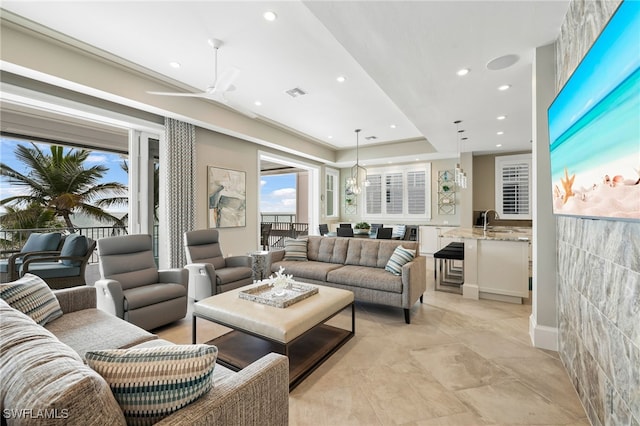 living room with ceiling fan, visible vents, and recessed lighting