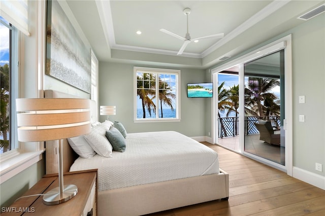 bedroom featuring visible vents, hardwood / wood-style flooring, access to outside, crown molding, and baseboards