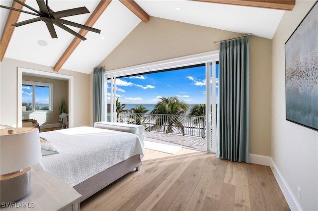 bedroom with multiple windows, lofted ceiling with beams, light wood-style floors, and access to outside