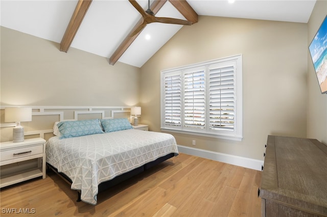 bedroom featuring lofted ceiling with beams, baseboards, and wood finished floors