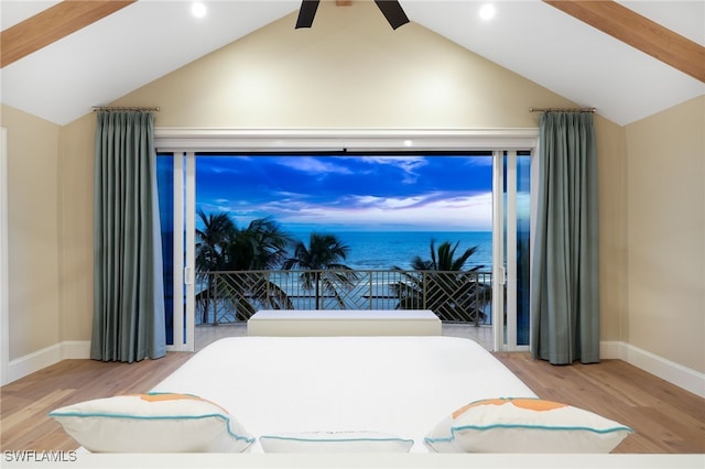 bedroom featuring lofted ceiling, wood finished floors, and baseboards