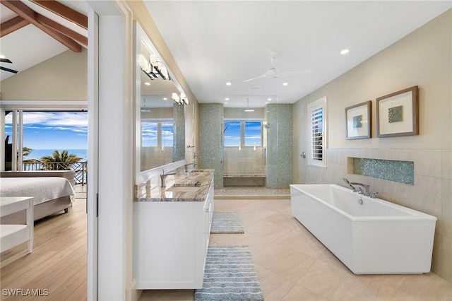 full bathroom with a soaking tub, walk in shower, ceiling fan, and vanity