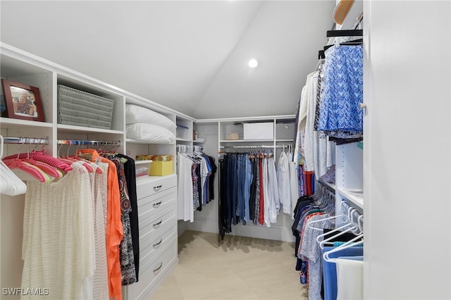 spacious closet featuring light floors and lofted ceiling