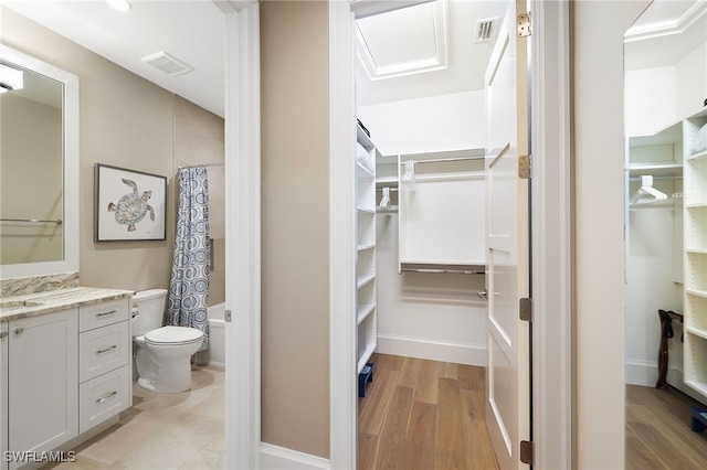 walk in closet featuring a sink, visible vents, and light wood-style flooring