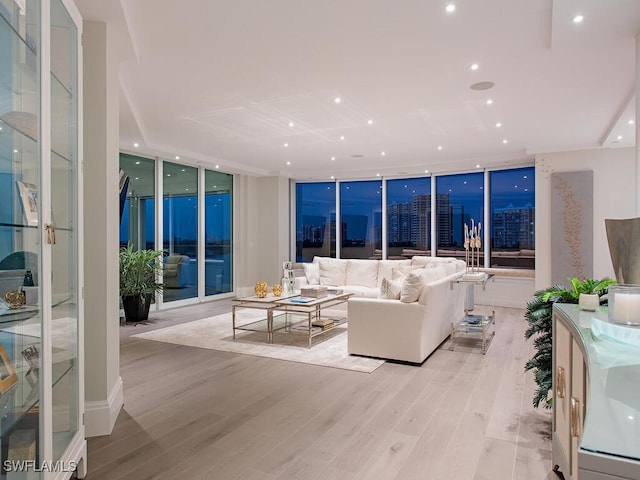 living area featuring recessed lighting, light wood finished floors, and expansive windows