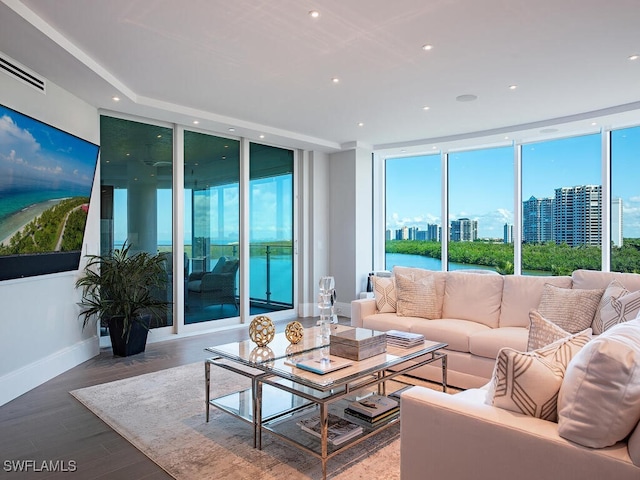 living room with visible vents, a city view, wood finished floors, recessed lighting, and baseboards