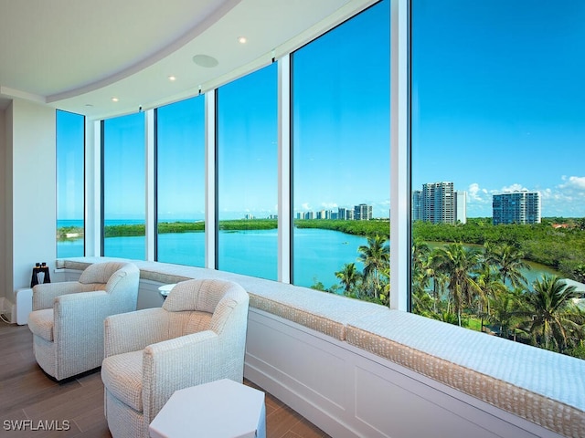 sunroom / solarium featuring a view of city and a water view