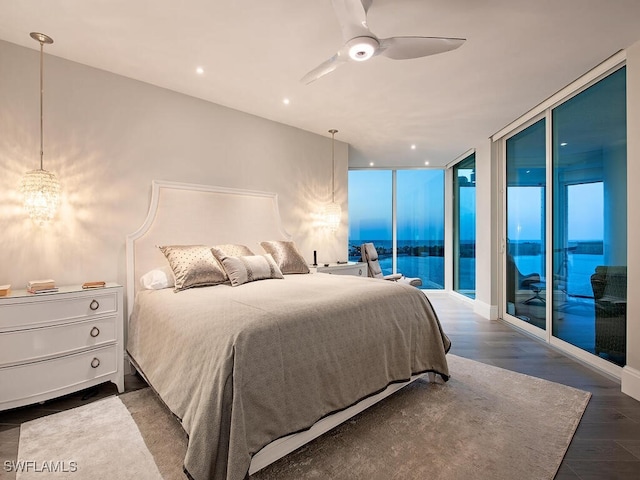 bedroom featuring ceiling fan, dark wood finished floors, expansive windows, recessed lighting, and access to outside