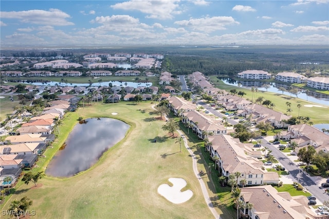 aerial view featuring a residential view, a water view, and golf course view