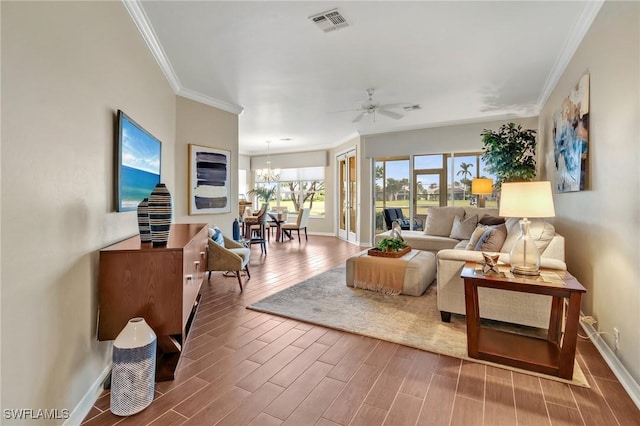 living room featuring visible vents, baseboards, and wood finished floors