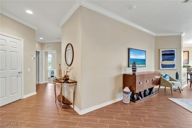 foyer featuring baseboards, visible vents, crown molding, wood finish floors, and recessed lighting