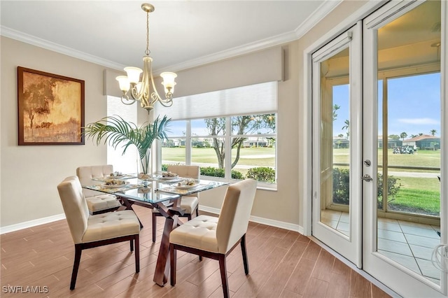 dining room featuring wood tiled floor, ornamental molding, and french doors