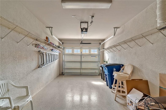 garage featuring a textured wall and a garage door opener