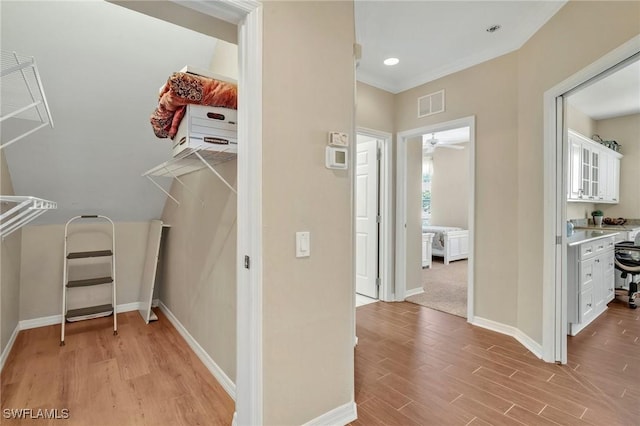 interior space with light wood-style floors and visible vents