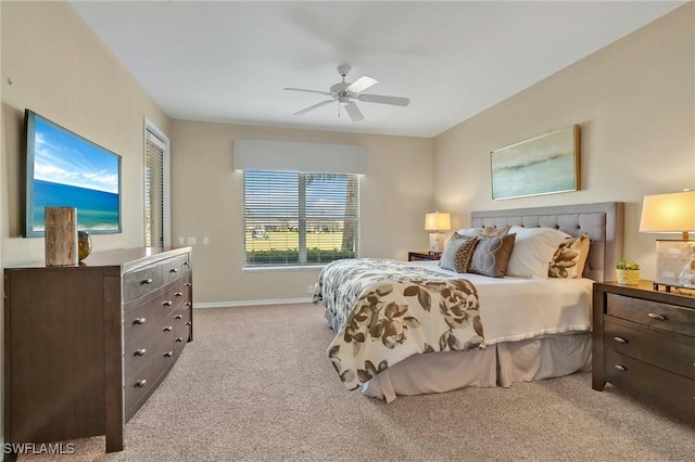 bedroom with baseboards, a ceiling fan, and light colored carpet