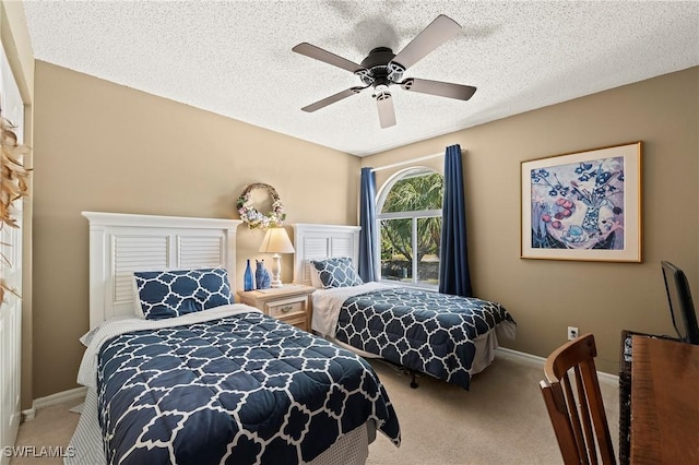 bedroom with a ceiling fan, carpet, a textured ceiling, and baseboards