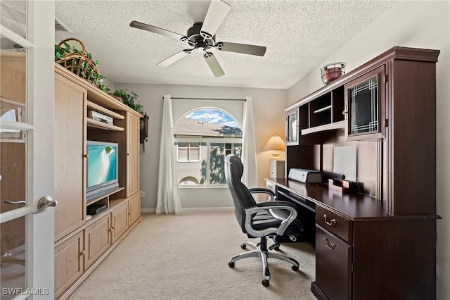 office with light carpet, ceiling fan, a textured ceiling, and baseboards