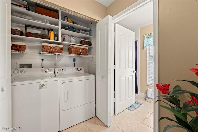 washroom with laundry area, light tile patterned floors, and separate washer and dryer