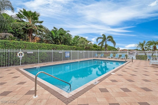 community pool featuring a patio area and fence