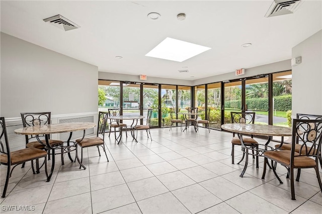 sunroom / solarium featuring a skylight and visible vents