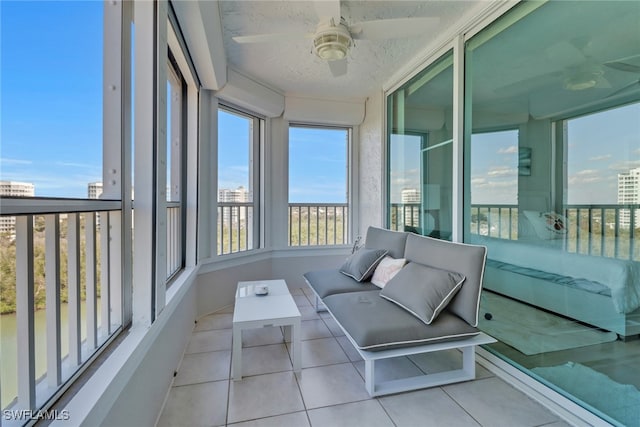 unfurnished sunroom with ceiling fan