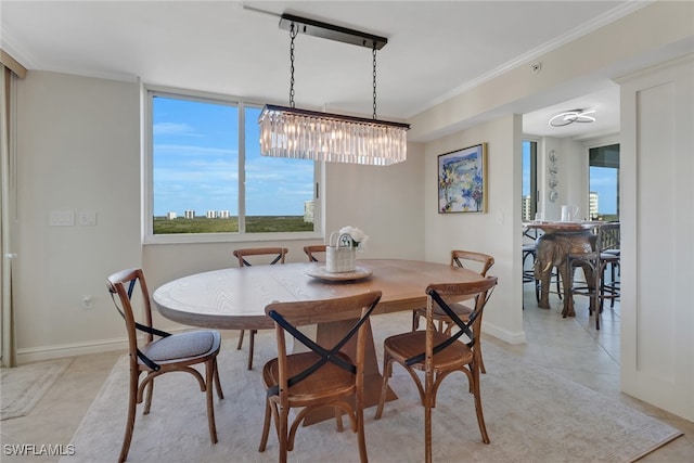 dining space with baseboards, light tile patterned flooring, and crown molding