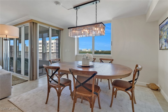 dining area featuring baseboards, ornamental molding, and light tile patterned flooring