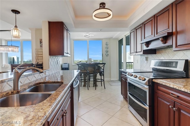 kitchen with decorative backsplash, a raised ceiling, stainless steel appliances, crown molding, and a sink