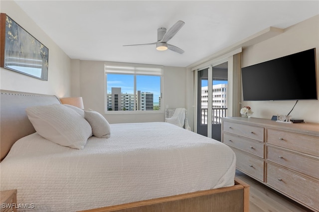 bedroom featuring access to exterior, ceiling fan, and wood finished floors