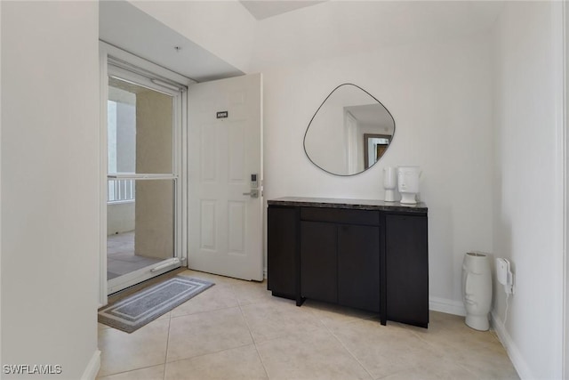 bathroom featuring vanity, baseboards, and tile patterned floors