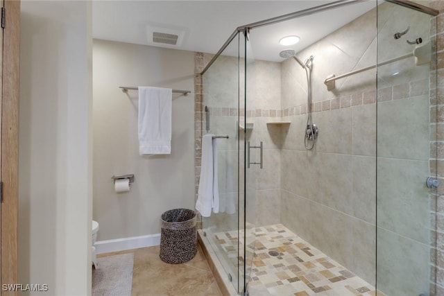 bathroom with a stall shower, baseboards, visible vents, toilet, and tile patterned flooring