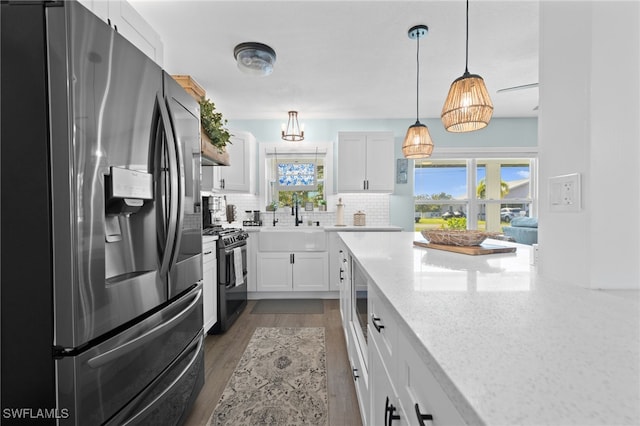 kitchen with stainless steel fridge with ice dispenser, a sink, white cabinets, range with gas cooktop, and tasteful backsplash