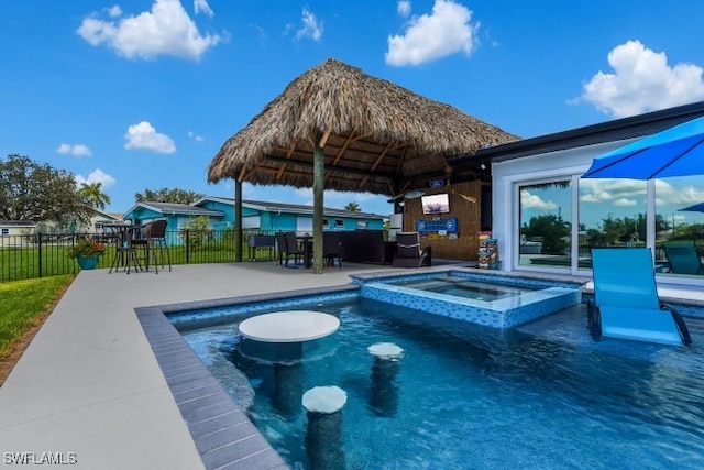 view of swimming pool featuring a gazebo, a patio, fence, and a pool with connected hot tub