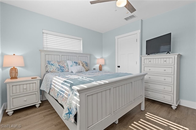 bedroom featuring visible vents, wood finished floors, and a ceiling fan