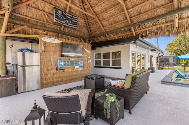 view of patio featuring a gazebo, outdoor lounge area, and fence