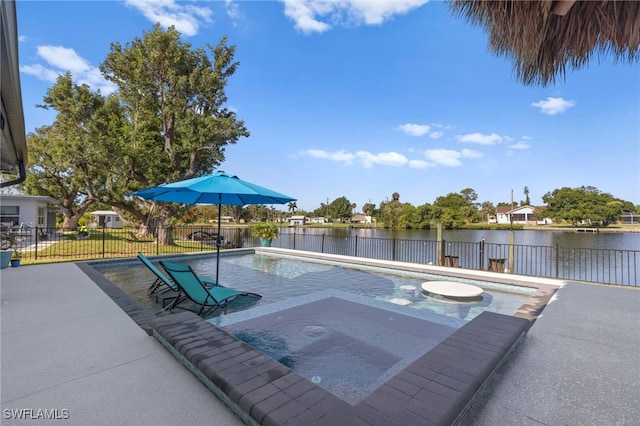 view of pool with a patio area, a water view, an in ground hot tub, and fence