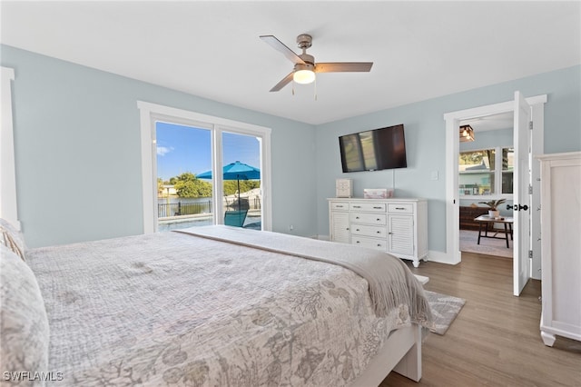 bedroom with a ceiling fan, baseboards, and wood finished floors