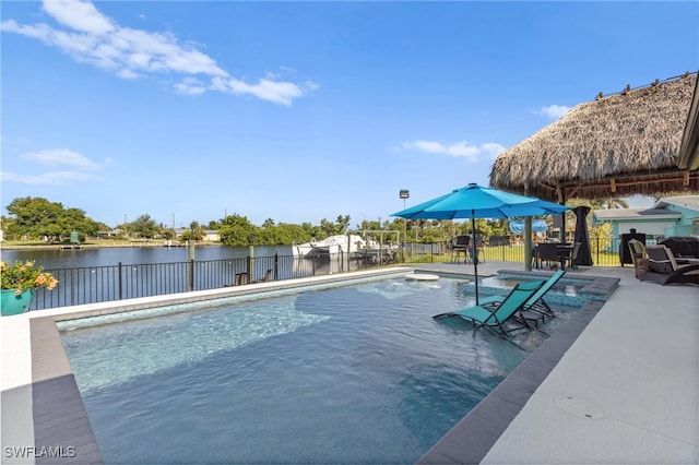 view of swimming pool with a fenced in pool, a water view, a patio, and fence